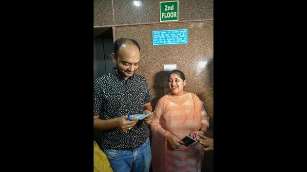 Mohammad Anas Siddiqui and Tanvi Seth show passports issued to them by the Regional Passport Office in Lucknow on Thursday. Siddiqui and Seth had applied for their passports on June 19 and during an appointment for June 20 were allegedly humiliated and shamed by passport officer Vikas Mishra before he rejected their application at a Passport Office in Lucknow. (Nand Kumar / PTI)