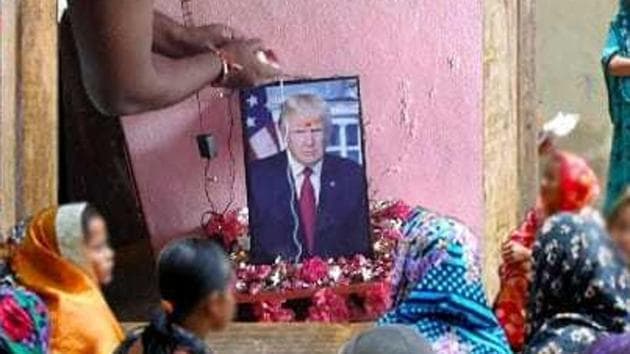 Bussa Krishna performs puja for a photo of US president Donald Trump at his home.(HT Photo)