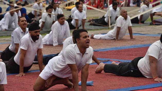 To mark this ancient practice that began in India more than 5,000 years ago, a yoga session was organised at Dholewal Military Complex in Ludhiana. (Gurpreet Singh / HT Photo) To mark this ancient practice that began in India more than 5,000 years ago, a yoga session was organised at Dholewal Military Complex in Ludhiana. (Gurpreet Singh / HT Photo)