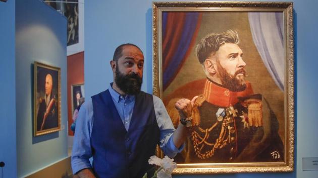 Italian artist Fabrizio Birimbelli stands next to his portrait of Argentine football star Lionel Messi. (AP)