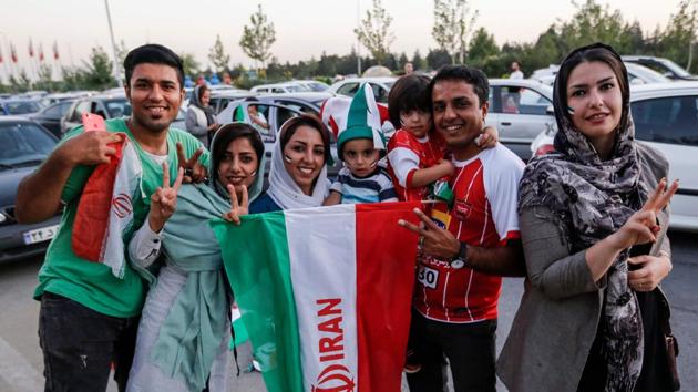 Iranian football supporters dressed in their national team's colours and paraphernalia pose with their national flag as they arrive outside Azadi stadium in Tehran on Wednesday to attend the screening of the FIFA World Cup Group B match between Iran and Spain. Riding on Diego Costa’s strike, Spain beat Iran 1-0. (AFP) Iranian football supporters dressed in their national team's colours and paraphernalia pose with their national flag as they arrive outside Azadi stadium in Tehran on Wednesday to attend the screening of the FIFA World Cup Group B match between Iran and Spain. Riding on Diego Costa’s strike, Spain beat Iran 1-0. (AFP)