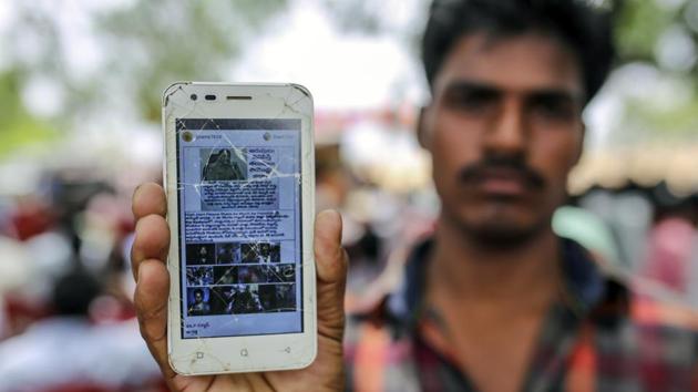 In the village of Balgera, Thirumalesh Boya, a 21-year-old construction worker, holds up his battered smartphone to show a bogus message featuring the image of a policeman. “High Alert Please Share As Much As Possible,” it says, before warning of murderous gangs. Boya says he forwarded the message, before learning better from the police. (Dhiraj Singh / Bloomberg)