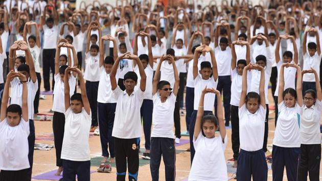 More than 8,000 National Cadet Corps (NCC) cadets perform yoga on the occasion of the 4th International Yoga Day at the Field Marshal Manekshaw Parade ground in Bengaluru on Thursday.(Arijit Sen/HT Photo)