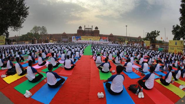 Women defence personnel during a yoga session organised by the Ministry of AYUSH for health and wellness at Red Fort ground, New Delhi. In today’s fast changing time, Yoga binds together a person’s body, brain and soul, hence making one experience a feeling of peace, said PM Modi while addressing the gathering at Forest Research Institute in Dehradun. (Sonu Mehta / HT Photo) Women defence personnel during a yoga session organised by the Ministry of AYUSH for health and wellness at Red Fort ground, New Delhi. In today’s fast changing time, Yoga binds together a person’s body, brain and soul, hence making one experience a feeling of peace, said PM Modi while addressing the gathering at Forest Research Institute in Dehradun. (Sonu Mehta / HT Photo)