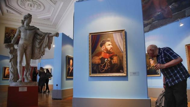 A visitor examines a portrait of Argentina footballer Lionel Messi at the Museum of Academy of Arts in St Petersburg. (AP)