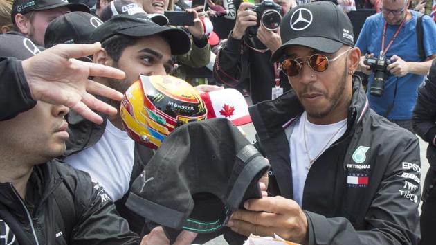 Lewis Hamilton signs autographs for fans at the French Grand Prix on Thursday. (AP) Lewis Hamilton signs autographs for fans at the French Grand Prix on Thursday. (AP)