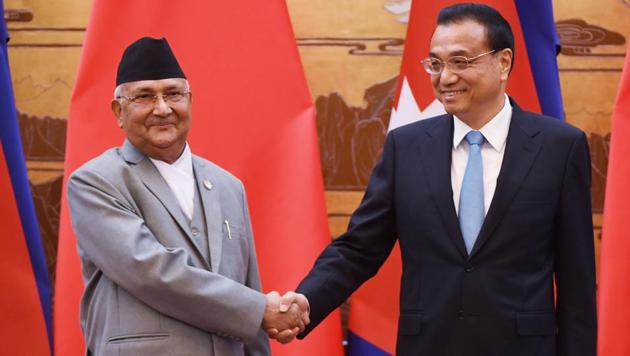 Nepal's Prime Minister KP Sharma Oli (left) shakes hands with Chinese Premier Li Keqiang during a signing ceremony at the Great Hall of the People in Beijing on Thursday.(AFP Photo)