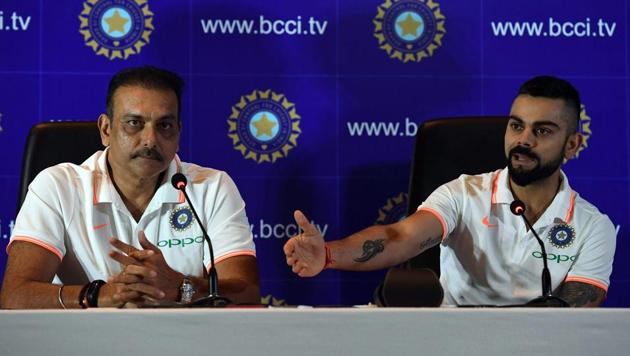 Indian cricket team head coach Ravi Shastri (L) watches as captain Virat Kohli speaks during a press conference in New Delhi on June 22, 2018.(AFP)