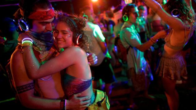 A couple embraces while dancing in a silent disco on the fourth and final day of the Firefly Music Festival in Dover, Delaware US. (Mark Makela / REUTERS)