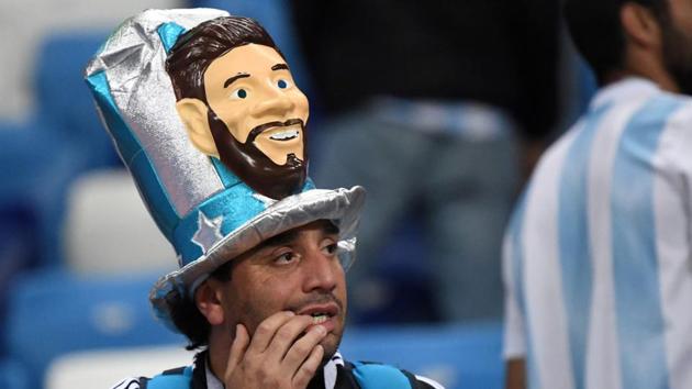 An Argentina's fan wearing a fancy hat depicting Lionel Messi reacts after his team lost to Croatia in a FIFA World Cup 2018 match at the Nizhny Novgorod Stadium. (AFP)