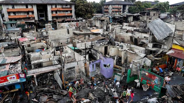 Fire victims collect recyclables after a fire in Quezon City. The Bureau of Fire Protection said the so-called informal settlers complicate efforts to save property and lives. Fire engines struggle to navigate along pathways littered with vehicles, food carts and stalls. (Erik De Castro / REUTERS) Fire victims collect recyclables after a fire in Quezon City. The Bureau of Fire Protection said the so-called informal settlers complicate efforts to save property and lives. Fire engines struggle to navigate along pathways littered with vehicles, food carts and stalls. (Erik De Castro / REUTERS)