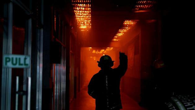 A fireman signals to fellow firefighters as a shopping centre burns at the University of the Philippines campus in Quezon City. Fire safety and building codes are unheard of. For the capital’s thousands of firefighters, the slums are sprawling, unregulated tinderboxes. (Erik De Castro / REUTERS) A fireman signals to fellow firefighters as a shopping centre burns at the University of the Philippines campus in Quezon City. Fire safety and building codes are unheard of. For the capital’s thousands of firefighters, the slums are sprawling, unregulated tinderboxes. (Erik De Castro / REUTERS)