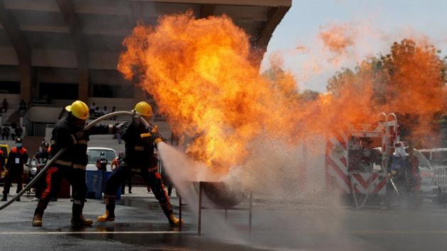 Firemen put out a fire as they compete during the annual Fire Olympics by firefighters nationwide in Manila. The city’s firefighters are on duty for 24-hour shifts. While they wait, they doze, work out, play sports or practise drills. (Erik De Castro / REUTERS) Firemen put out a fire as they compete during the annual Fire Olympics by firefighters nationwide in Manila. The city’s firefighters are on duty for 24-hour shifts. While they wait, they doze, work out, play sports or practise drills. (Erik De Castro / REUTERS)