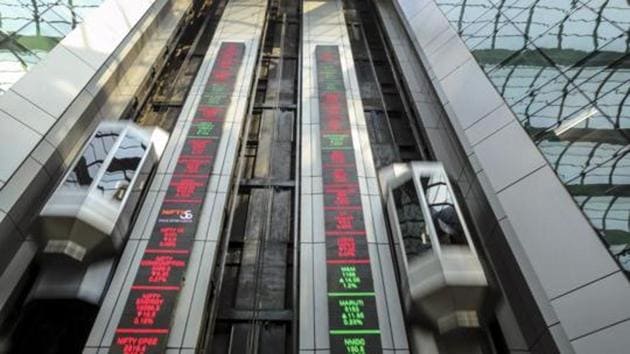 Elevators travel next to electronic boards displaying stock figures at the National Stock Exchange of India Ltd. (NSE) building in Mumbai.(Dhiraj Singh/Bloomberg)