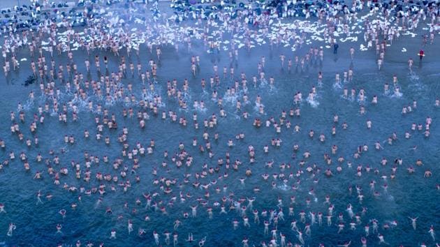 Participants of the Dark Mofo Nude Solstice Swim are seen in the River Derwent at dawn, in Hobart, Australia. (Rob Blakers / AAP via REUTERS)