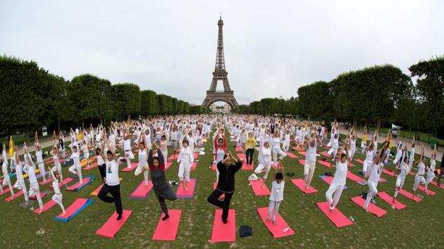 People gather for an open-air yoga session near the Eiffel tower in Paris, France. (Philippe Wojazer / REUTERS)