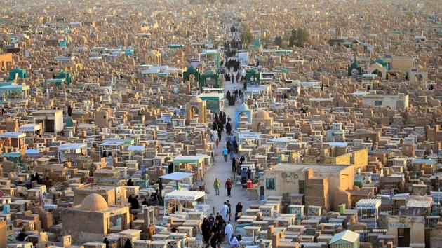 People visit the “Valley of Peace” cemetery during Eid al-Fitr as they mark the end of the fasting month of Ramadan, in Najaf, Iraq. (Alaa Al-Marjani / REUTERS)