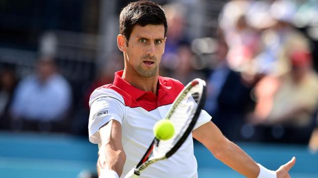 Novak Djokovic returns against Bulgaria's Grigor Dimitrov during their Queen's Club Championships match on Thursday.(AFP)