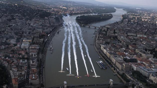 Peter Besenyei of Hungary (3rd L) leads Petr Kopfstein of the Czech Republic, Michael Goulian of the United States, Matt Hall of Australia and Ben Murphy of Great Britain over the city prior to the fourth stage of the Red Bull Air Race World Championship in Budapest, Hungary. (Joerg Mitter / Limex Images / AFP)