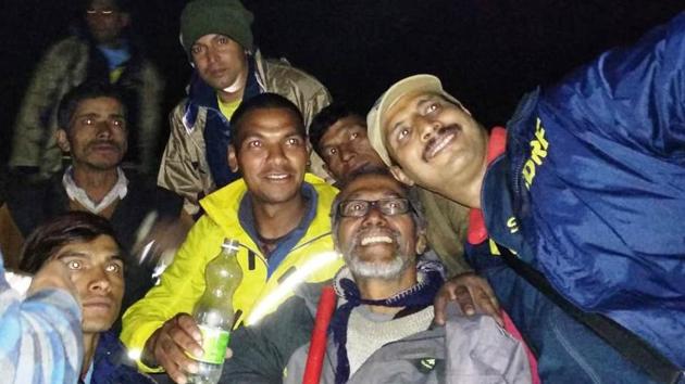 Uttarakhand State Disaster Response Force personnel take a selfie with 67-year-old trekker S Prema Chandran from Thiruvananthapuram after rescuing him from Chamoli district. (HT Photo) Uttarakhand State Disaster Response Force personnel take a selfie with 67-year-old trekker S Prema Chandran from Thiruvananthapuram after rescuing him from Chamoli district. (HT Photo)