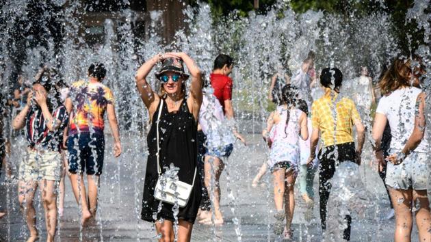 A tourist cools herself at a fountain at Muzeon Park in Moscow on June 22, 2018. (AFP) A tourist cools herself at a fountain at Muzeon Park in Moscow on June 22, 2018. (AFP)