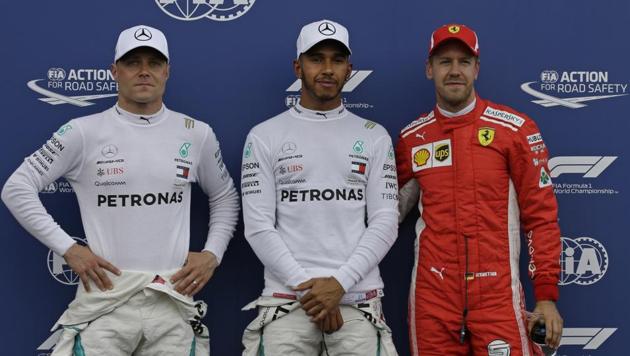Mercedes driver Lewis Hamilton (C), who clocked the fastest time to claim pole position, stands next to second placed Mercedes driver Valtteri Bottas (L) and third placed Ferrari driver Sebastian Vettel after qualifying at the Paul Ricard racetrack in Le Castellet, southern France, on Saturday. (AP) Mercedes driver Lewis Hamilton (C), who clocked the fastest time to claim pole position, stands next to second placed Mercedes driver Valtteri Bottas (L) and third placed Ferrari driver Sebastian Vettel after qualifying at the Paul Ricard racetrack in Le Castellet, southern France, on Saturday. (AP)