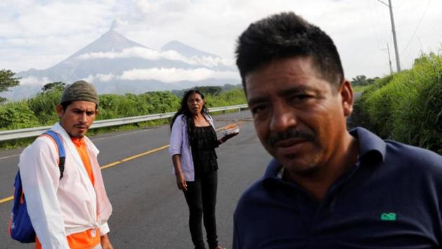 Garcia holds food as she walks to her town in search of her family on the outskirts of San Miguel Los Lotes. She has been sleeping in a school room with other survivors after she lost her family and home. Fuego’s volcano on June 3 ejected tons of earth, ash and colossal stones that buried hundreds of homes and left at least 112 people dead. (Carlos Jasso / REUTERS)