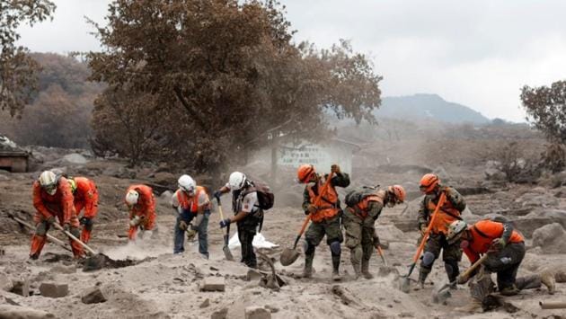 Mexican volunteer rescue workers search the house of one of Garcia's missing sisters in an area affected by the volcano. But the Guatemalan rescue workers only searched during the first three days after the tragedy, calling off efforts as the volcano continued to rumble. (Carlos Jasso / REUTERS)
