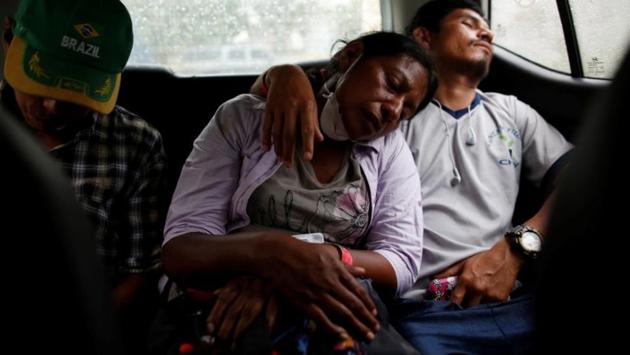 Garcia sleeps next to her partner, Fito Perez, after searching for her family in the homes buried by ash. In the early days after the eruption, Garcia thought she had lost all her six children. (Carlos Jasso / REUTERS)