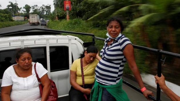 Garcia takes a ride with other residents after a day spent searching for her family. “The volcano has calmed down. It is nothing to worry about, because everything that it had to blow has already been blown out. So now, with the permission of our Lord and the volcano, we are working,” she said. (Carlos Jasso / REUTERS)