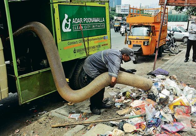 Imported equipment, like battery-powered Glutton vacuum litter pickers, Trilo vacuum trucks and trucks mounted with road sweepers have been deployed by the Poonawalla group for the collection of roadside trash; (Bottom) Workers segregate garbage collected from Vimannagar area using a trampoline sheet so that the waste does not litter the road again.(SHANKAR NARAYAN/HT PHOTO)