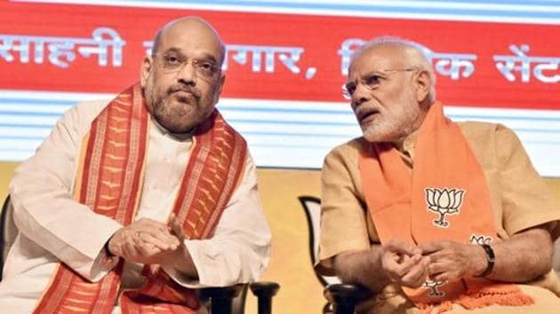 Prime Minister Narendra Modi speaks with BJP national president Amit Shah during the concluding session of the National Executive Committee meeting of the party's all wings (morchas) in New Delhi, on May 17, 2018.(Sonu Mehta/HTFile Photo)