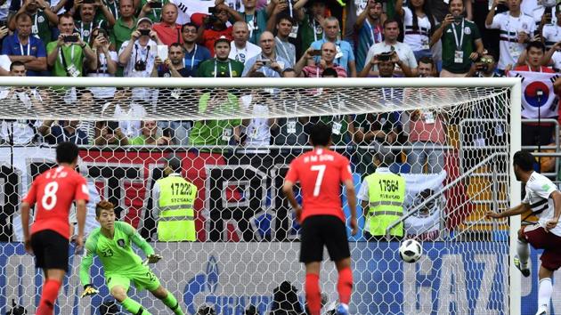 Mexico's Carlos Vela, right, scores his side's opening goal from a penalty kick during the group F match between Mexico and South Korea at the 2018 soccer World Cup. (AP)