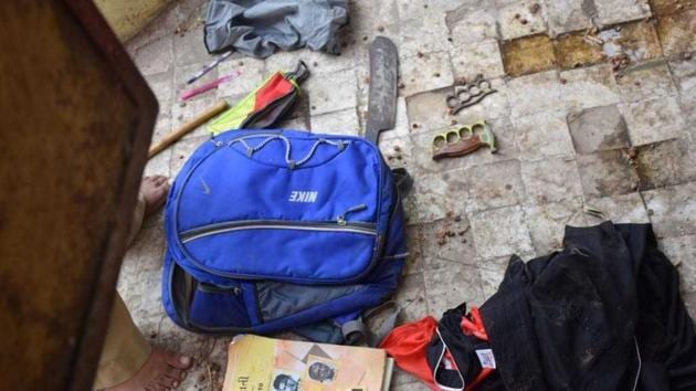 A school bag belonging to the accused was found on the terrace of a temple near the school building in Vadodara. It contained three big knives and a bottle filled with red chilli solution.(HT Photo)