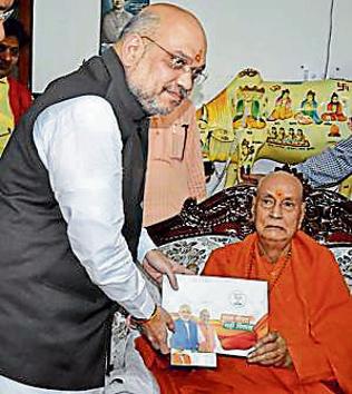 BJP president Amit Shah meets Swami Satyamitranand Maharaj, a former Shankaracharya, as part of the 'Sampark Se Samarthan' campaign in Haridwar on Sunday. (PTI Photo) BJP president Amit Shah meets Swami Satyamitranand Maharaj, a former Shankaracharya, as part of the 'Sampark Se Samarthan' campaign in Haridwar on Sunday. (PTI Photo)