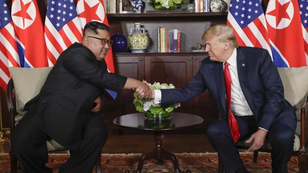 US President Donald Trump shakes hands with North Korea leader Kim Jong Un (left) during their first meeting at the Capella resort on Sentosa Island on June 12 in Singapore.(AP file photo)