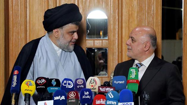 Iraqi Prime Minister Haider al-Abadi (R) attend a press conference with Iraqi Shiite cleric and leader Moqtada al-Sadr in Najaf on June 23, 2018. /(AFP) Iraqi Prime Minister Haider al-Abadi (R) attend a press conference with Iraqi Shiite cleric and leader Moqtada al-Sadr in Najaf on June 23, 2018. /(AFP)