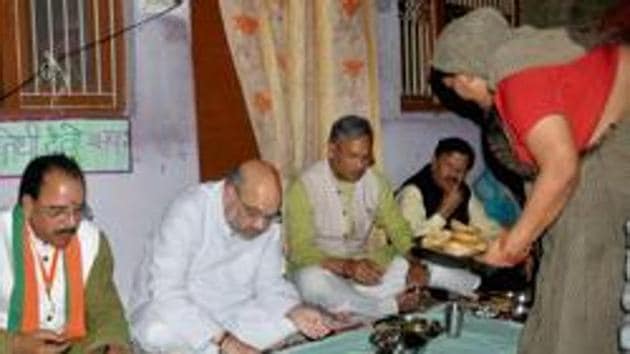 BJP national president Amit Shah (2nd from left) along with chief minister Trivendra Singh Rawat had lunch at a Dalit's house in Dehradun last year. (PTI File) BJP national president Amit Shah (2nd from left) along with chief minister Trivendra Singh Rawat had lunch at a Dalit's house in Dehradun last year. (PTI File)