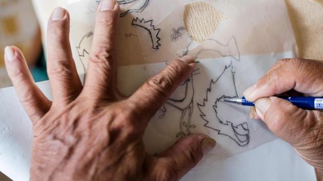 Nguyen Thanh Tam makes paper cutouts for additional fixtures on his model of Zabivaka. “Over the past few years, I have been spending my time making football mascots with eggshells as a way for me to show my love for football,” Tam said. Though not widespread in Vietnam, eggshells in art are not unheard of: traditional lacquer works often feature inlaid eggshell in lieu of white paint. (Thanh Nguyen / AFP) Nguyen Thanh Tam makes paper cutouts for additional fixtures on his model of Zabivaka. “Over the past few years, I have been spending my time making football mascots with eggshells as a way for me to show my love for football,” Tam said. Though not widespread in Vietnam, eggshells in art are not unheard of: traditional lacquer works often feature inlaid eggshell in lieu of white paint. (Thanh Nguyen / AFP)
