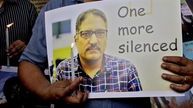 A journalist participates in a silent protest against the brutal killing of a senior Kashmiri journalist Shujaat Bukhari, in Kolkata.(AP Photo)