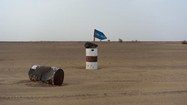 A bullet-ridden barrel indicates the direction of Arlit in Niger’s Tenere. An EU spokesperson said they were aware of what Algeria was doing, but that “sovereign countries” can expel migrants as long as they comply with international law. Unlike Niger, Algeria takes none of the EU money intended to help with the migration crisis, although it did receive $111.3 million in aid from Europe between 2014 and 2017. (Jerome Delay / AP)