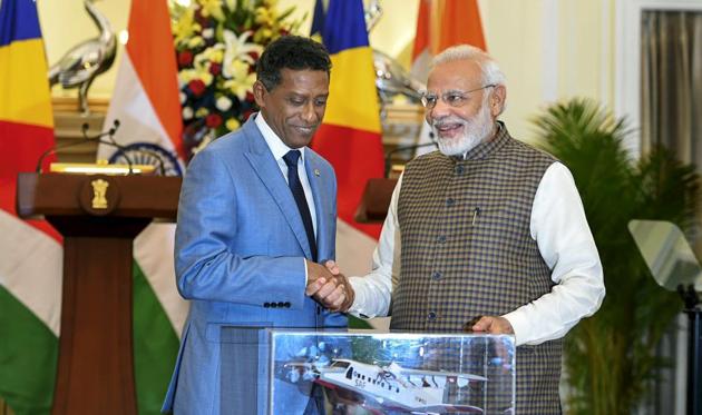 New Delhi: Prime Minister Narendra Modi pose for a photo with model of Dornier aircraft which will be gifted to Seychelles President Danny Antoine Rollen Faure after their meeting at Hyderabad House, in New Delhi on Monday, June 25, 2018. (PTI Photo/Shahbaz Khan) (PTI6_25_2018_000086B)(PTI)