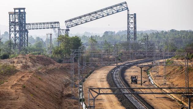 A tractor drives past a rail track running through the site of the thermal power plant. Today it stands deserted and banks have had to write off three quarters of their loans. Haircuts of that magnitude are now expected across the whole power sector, which is still reeling from the 2014 court-ordered loss of coal mining permits. (Prashanth Vishwanathan / Bloomberg) A tractor drives past a rail track running through the site of the thermal power plant. Today it stands deserted and banks have had to write off three quarters of their loans. Haircuts of that magnitude are now expected across the whole power sector, which is still reeling from the 2014 court-ordered loss of coal mining permits. (Prashanth Vishwanathan / Bloomberg)