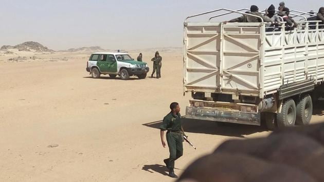 Algerian gendarmes load migrants onto trucks to drop them off at the Niger border. Algeria’s mass expulsions have picked up since October 2017, as the EU renewed pressure on North African countries to head off migrants going to Europe via the Mediterranean Sea or the barrier fences with Spain. Some sub-Saharan migrants are fleeing violence and others seek a living. (Ju Dennis / AP)
