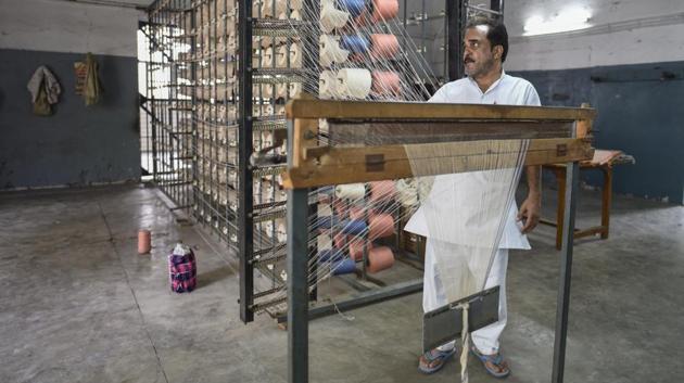 An inmate of Tihar jail works at weaving unit inside jail number 2 in New Delhi. From cakes and biscuits, LED bulbs, pickles, and furniture to blankets, power looms and designer clothes, thousands of prisoners spread across the jails’s 400 acres work across different units. Learning skills in the prison means hope for a better life once outside. (Burhaan Kinu / HT Photo) An inmate of Tihar jail works at weaving unit inside jail number 2 in New Delhi. From cakes and biscuits, LED bulbs, pickles, and furniture to blankets, power looms and designer clothes, thousands of prisoners spread across the jails’s 400 acres work across different units. Learning skills in the prison means hope for a better life once outside. (Burhaan Kinu / HT Photo)