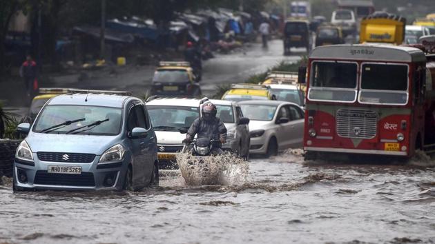 Mumbai rains: Vehicles wade through water-logged tracks during heavy rains, in Mumbai on Monday, June 25, 2018.(PTI)