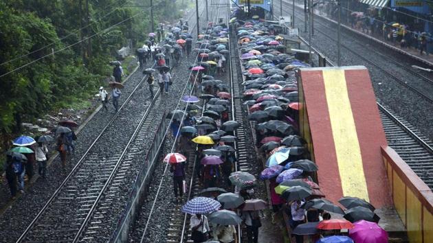 Passengers shield themselves under umbrellas at a railway station, in Kolkata. Five people were killed in lightning strikes and one drowned after heavy monsoon rains and thunderstorms lashed West Bengal. (PTI Photo) Passengers shield themselves under umbrellas at a railway station, in Kolkata. Five people were killed in lightning strikes and one drowned after heavy monsoon rains and thunderstorms lashed West Bengal. (PTI Photo)