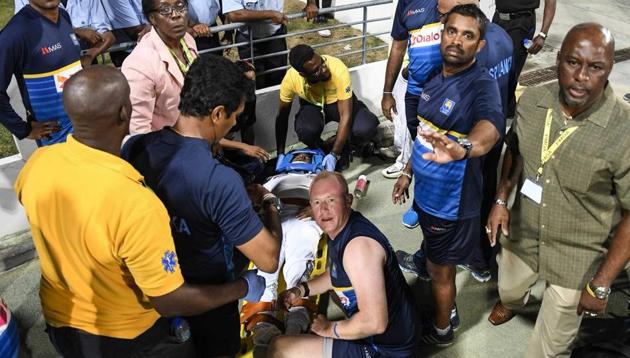 Medical staff attend to Kusal Perera during third day’s play of the day-night Test between Sri Lanka and West Indies in Barbados.(Twitter)