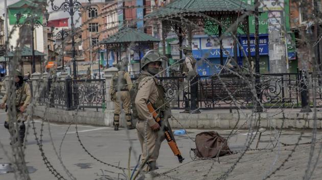 Paramilitary soldiers are seen through barbed wire in Srinagar on May 19, 2018.(AP File Photo)