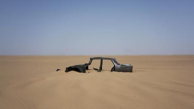 The frame of an abandoned Peugeot 404 rests in Niger’s Tenere. Thousands of other Nigerien migrants are expelled directly home because of a 2015 agreement between Niger and Algeria to deal with Nigeriens living illegally in Algeria. The number of migrants sent home in convoys — nearly all of them Nigerien — has also shot up, to at least 14,446 since August 2017, compared with 9,290 for all of 2016. (Jerome Delay / AP)